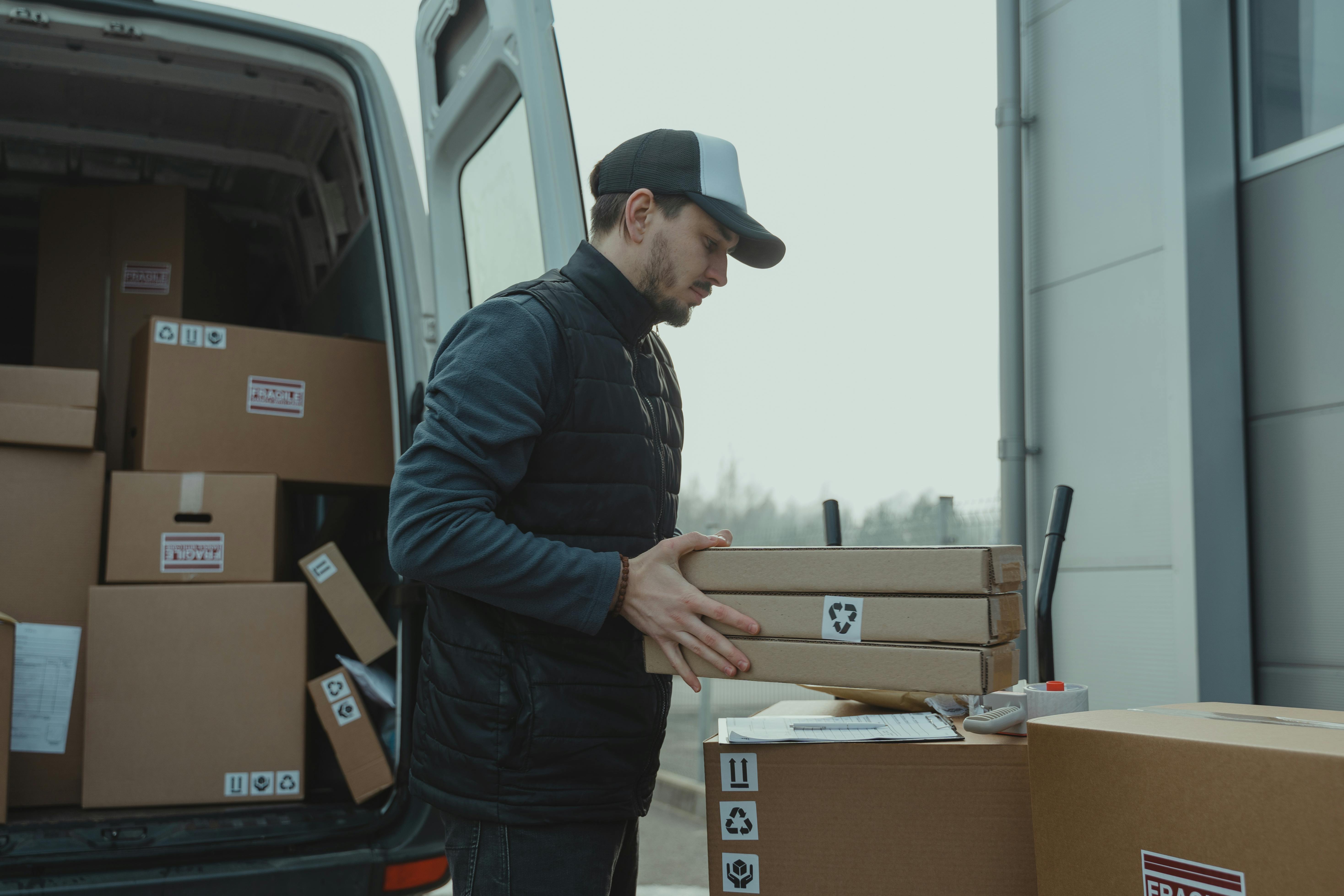 Delivery driver carrying a box of fresh produce.